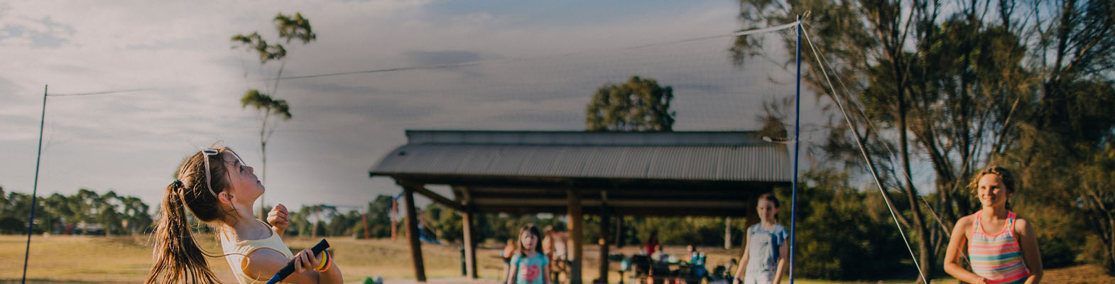 Children playing badmington in a park