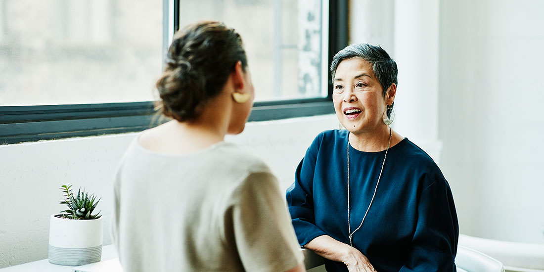 Two ladies talking in an office