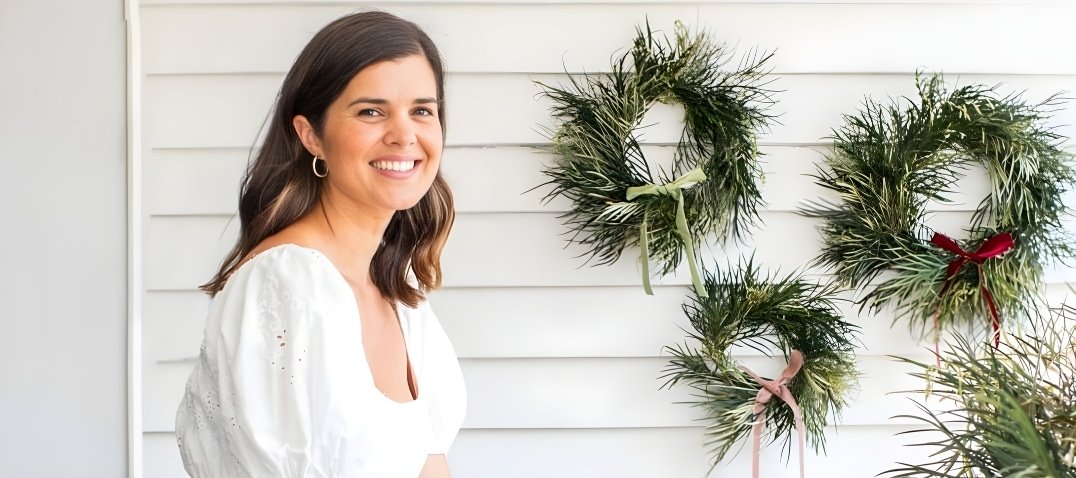 Geneva Vanderzeil with Christmas wreaths made from foraged foliage.