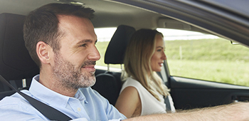 A man and a woman driving a car