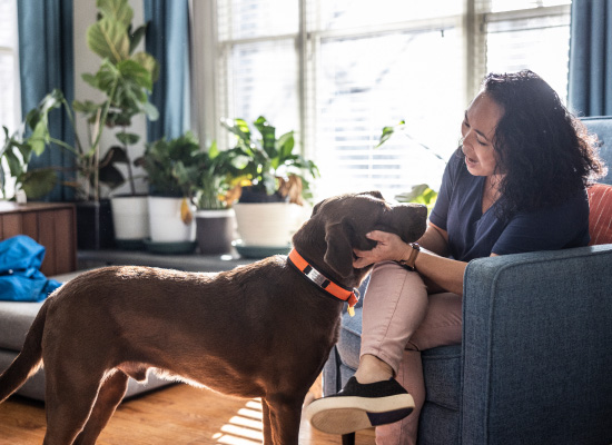 A tenant relaxing at home with her dog.